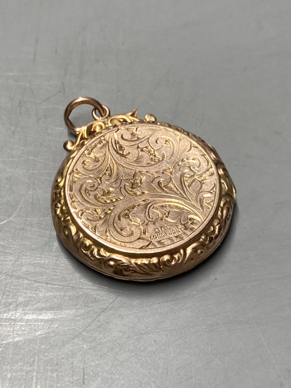 Two gold plated overlaid and gem set fob seals, largest 35mm, a 9ct front and back locket and a scroll brooch.